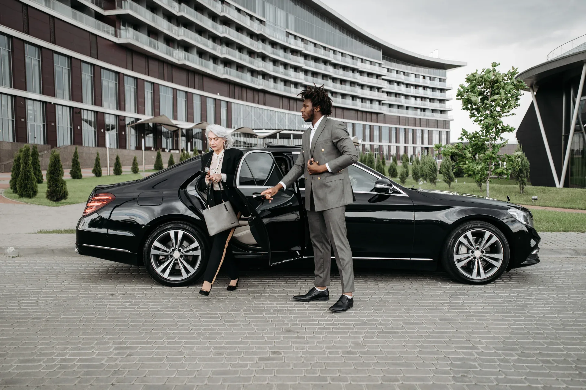 Chauffeur opening a car door for a guest