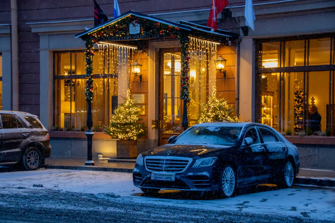 Luxury sedan outside a hotel at night